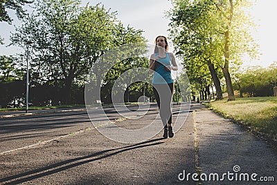 Young woman running, jogging in the park. Exercising outdoor Stock Photo