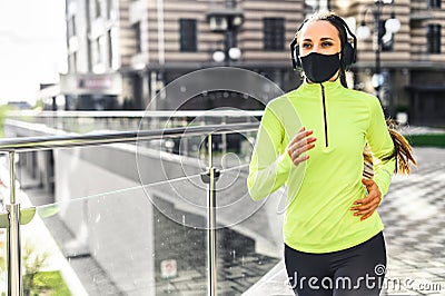 Young woman is running in medical mask Stock Photo