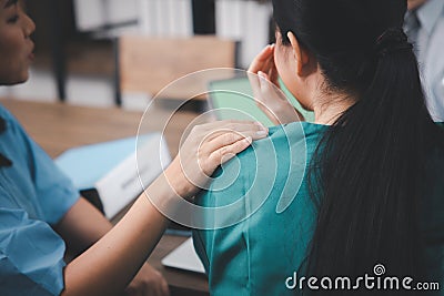 A young woman `s hand resting on her friend`s shoulder to comfort and encourage her Stock Photo