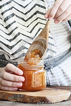Young Woman Canning Homemade Cantaloupe Jam Stock Photo