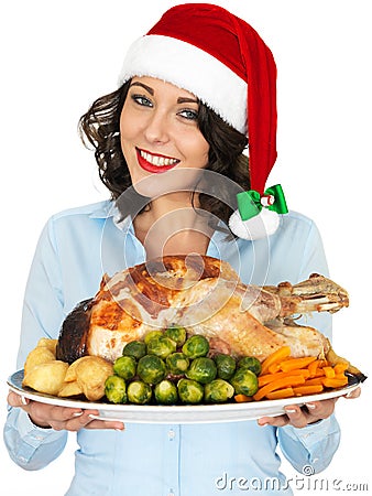 Young Woman in Santa Hat Holding Roast Turkey and Vegetables Stock Photo