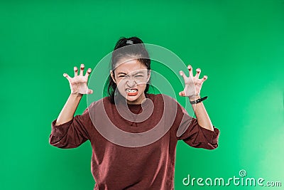 young woman screaming in panic or anger, shocked, terrified or furious, with hands next to head against Stock Photo