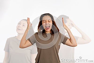 A young woman screams, arms outstretched. On a white background, the shadows of other human personalities. The concept of human Stock Photo