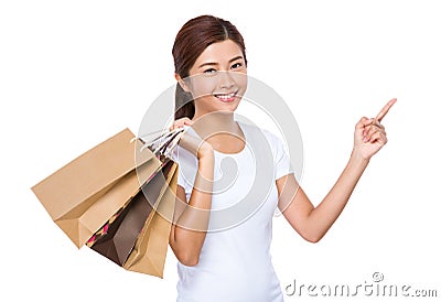 Young woman with shopping bag and finger point up Stock Photo