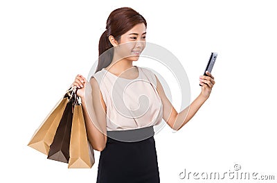 Young woman with shopping bag and using the mobile phone Stock Photo