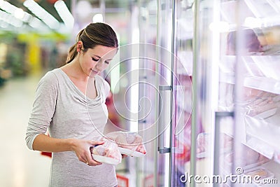 Young woman shopping for meat in a grocery store Stock Photo