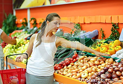 Young woman shopping in a supermarket in the department of fruit Stock Photo