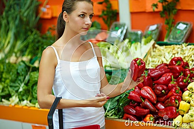 Young woman shopping in a supermarket in the department of fruit Stock Photo