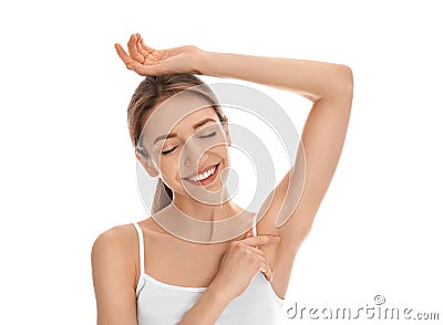 Young woman showing armpit with smooth clean skin on white background Stock Photo