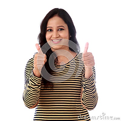 Young woman showing thumbsup gesture against white Stock Photo