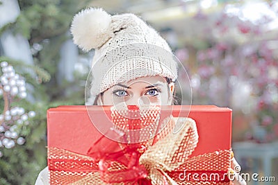 Young woman shows her gift packs inside a Christmas shop Stock Photo