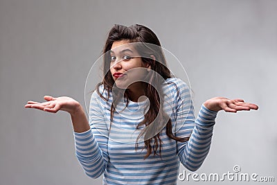 Young woman shrugging her shoulders Stock Photo