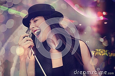 Young woman singing with the microphone Stock Photo