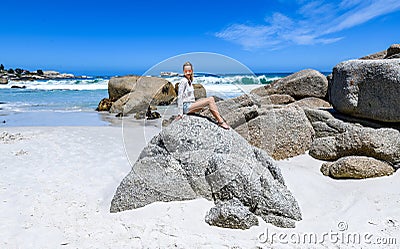 A young woman sittingon the boulders of clifton beach in the capetown area of south africa.2 Stock Photo