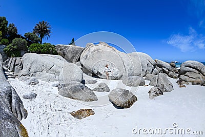 A young woman sittingon the boulders of clifton beach in the capetown area of south africa.5 Stock Photo