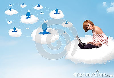 Young woman sitting in cloud with laptop Stock Photo