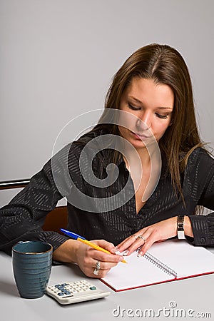 Young woman sitting at desk Stock Photo