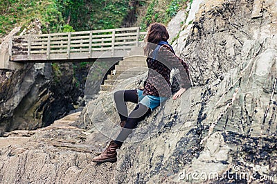 Young woman sitting on rocks Stock Photo