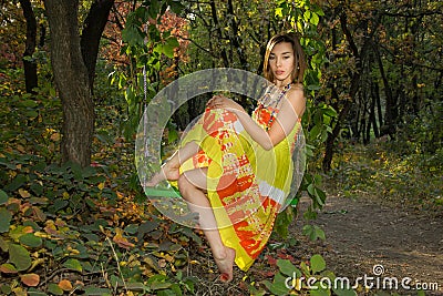 Young woman sitting on swing Stock Photo