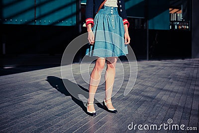 Young woman in skirt standing in the street Stock Photo