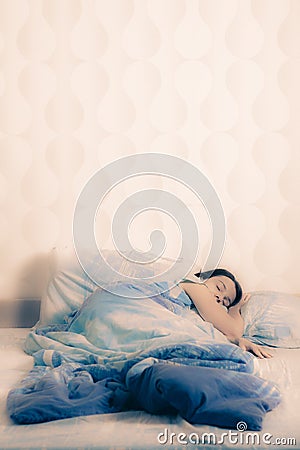 Young woman sleeping on the bed. concept of good sound sleep in a cozy bed. attractive girl lying in bed at home Stock Photo
