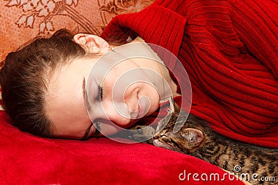 Young woman sleeping with kitten Stock Photo