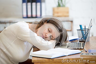 Young woman sleeping on office desk Stock Photo