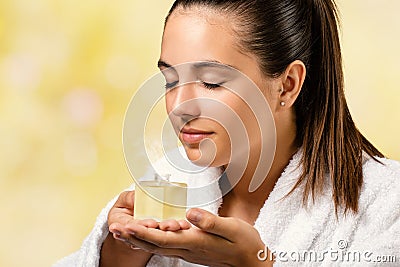 Young woman smelling essential oil fragrance. Stock Photo