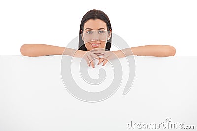 Young woman smiling behind white panel Stock Photo
