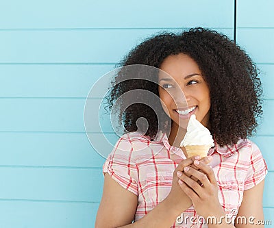 Young woman smiling and eating ice cream Stock Photo