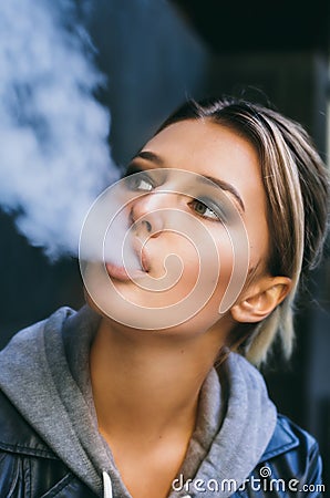 Young woman smoking Electronic Cigarette Stock Photo