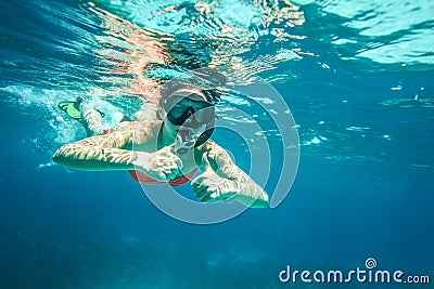 Young woman snorkel, holding two thumbs up Stock Photo