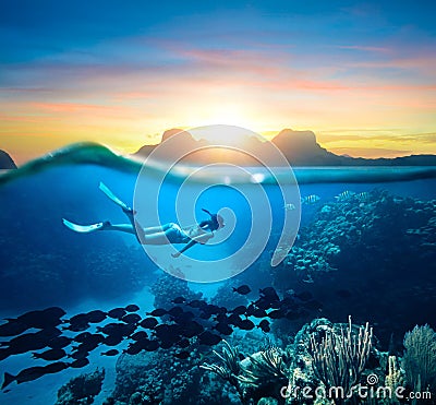 Woman snorkeling in clear tropical waters ocean on sunset day Stock Photo