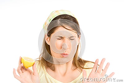 Young woman sour grimace with half of lemon Stock Photo