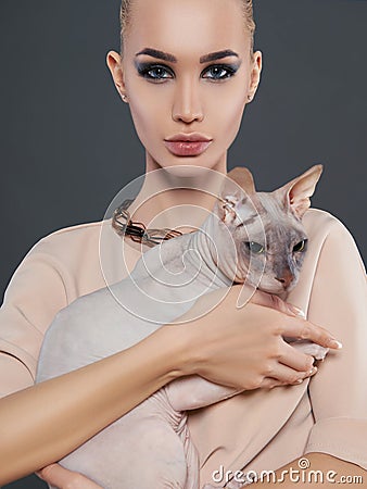 Young woman with Sphynx cat Stock Photo