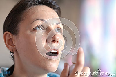 Young woman with spray inhaler Stock Photo