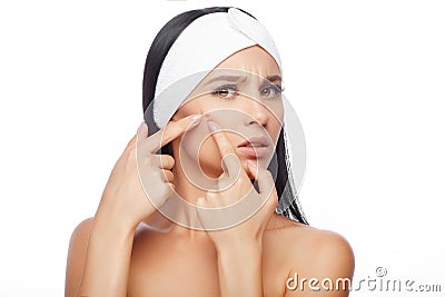 Young woman squeezing her pimple Stock Photo