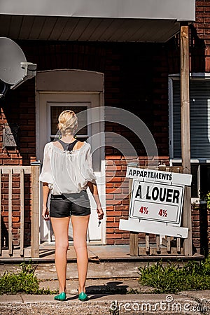 Young Woman standing in front of her new apartment Stock Photo
