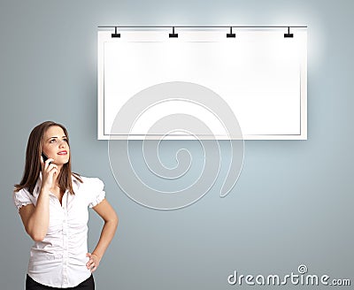 young woman standing next to a modern copy space and making phone call Stock Photo