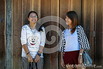 Young woman standing poses photographed with the old wooden door. Editorial Stock Photo