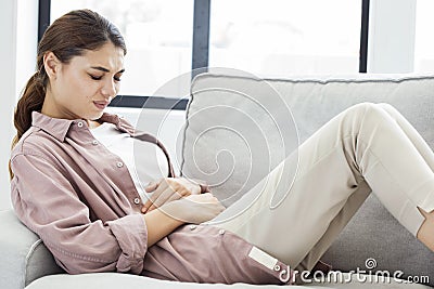 Young woman with stomach pain Stock Photo