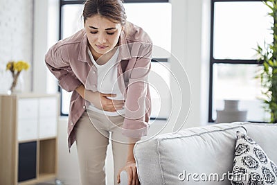 Young woman with stomach pain Stock Photo