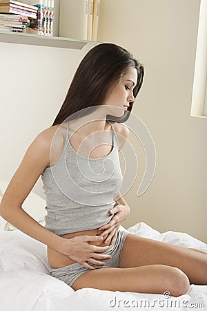 Young woman stroking her belly Stock Photo