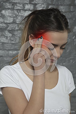 Young woman struggles with headache, side view Stock Photo