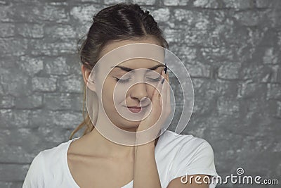Young woman struggles with toothache, hand in a place of pain Stock Photo