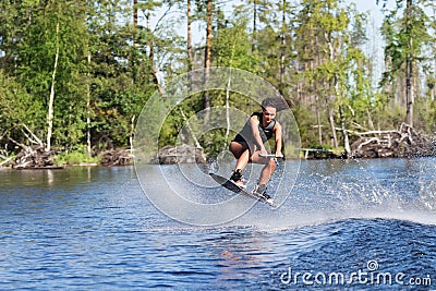 Young woman study riding wakeboarding on a lake Stock Photo