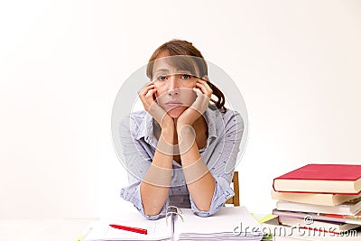 Young woman studying and reading in a library but is having a hard time understanding the material Stock Photo