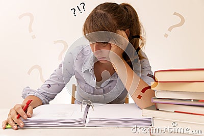 Young woman studying and reading in a library but is having a hard time understanding the material Stock Photo