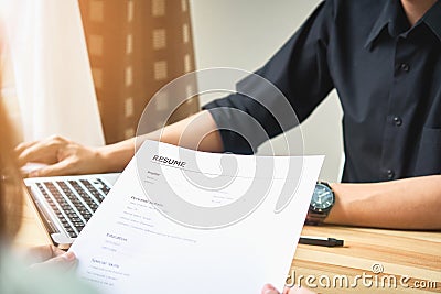 Young woman submit resume to employer to review job application. Stock Photo