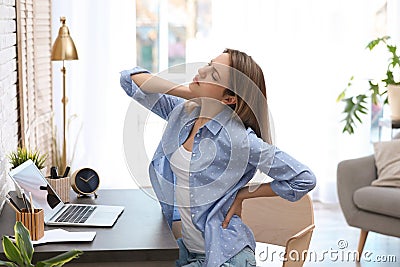 Young woman suffering from back pain Stock Photo